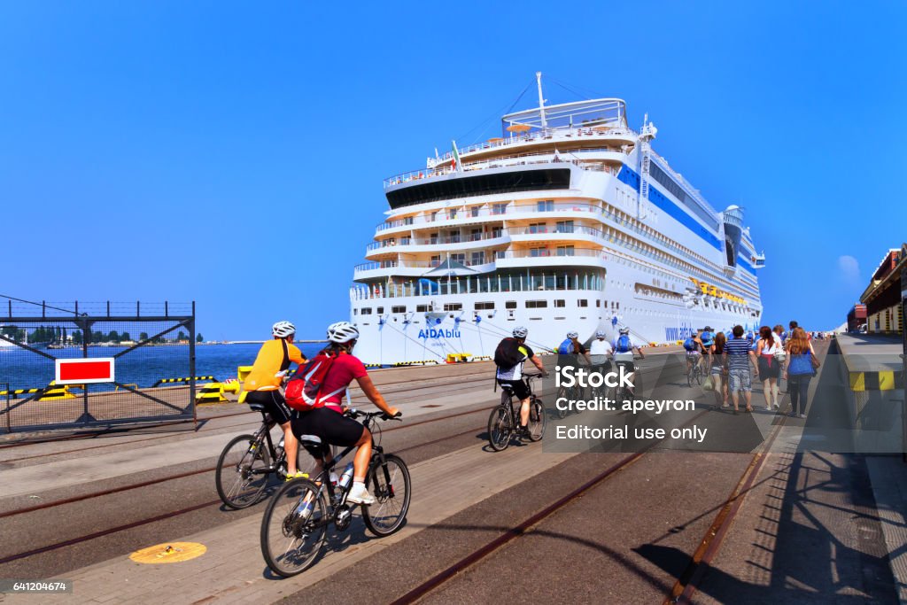 Gdynia, Poland - 07 28 2012: tourists on bikes returning back from the city trip to the big touristic cruise ship in the port of Gdynia Adult Stock Photo