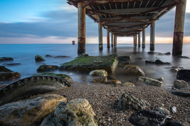 istock Abandoned bridge sunset, rubber and marine 641210850
