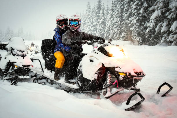 istock Couple snow mobile in snow storm 641212516
