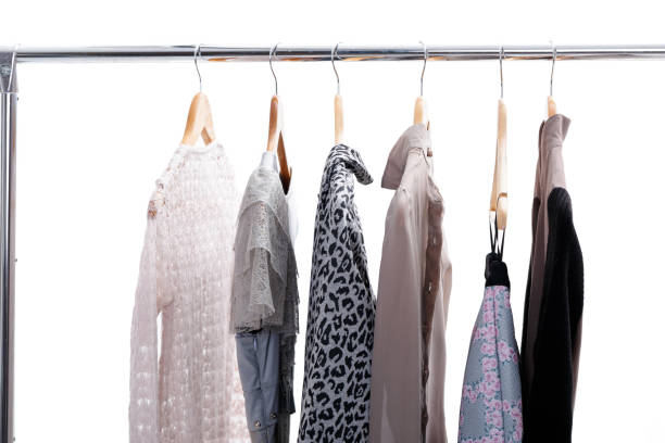 istock grey and beige womens clothes on hangers on rack on white backgr 641214096