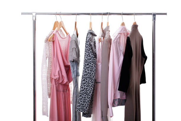 istock gray, pink womens clothes on hangers on rack on white background 641214134