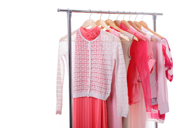istock pink womens clothes on hangers on rack on white background. clos 641214260