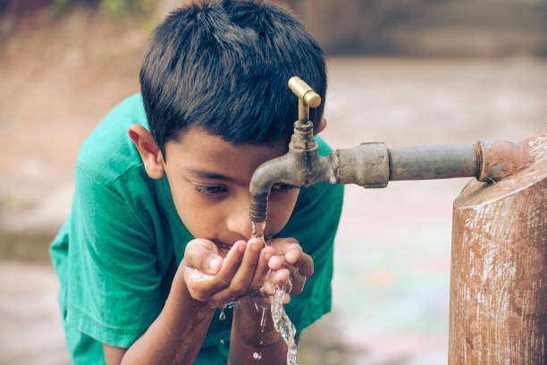 drinking water Indian boy drinking tap water outside kerala photos stock pictures, royalty-free photos & images