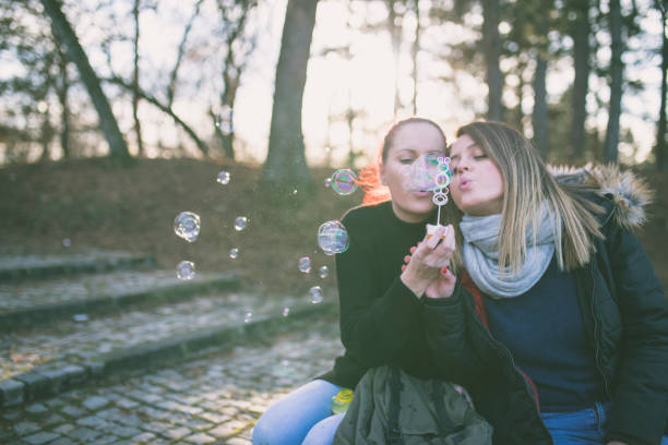 istock Young and beautiful girls blowing bubbles 641222906
