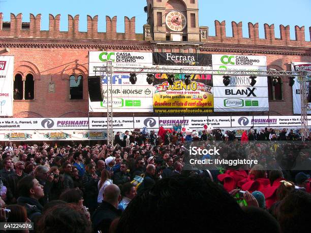 Cento Emiliaromagna Italy March 6 2011 In The Main Square Crowd Of Spectators And Dancers In Red Costume Near The Town Hall Under The Installation For Lights The Stage For The Awards Many Recognisable People And Advertising Posters Stock Photo - Download Image Now