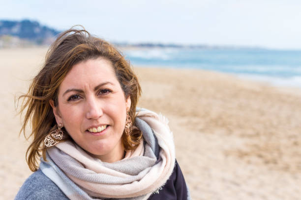 istock Forties smiling girl on the beach 641226408