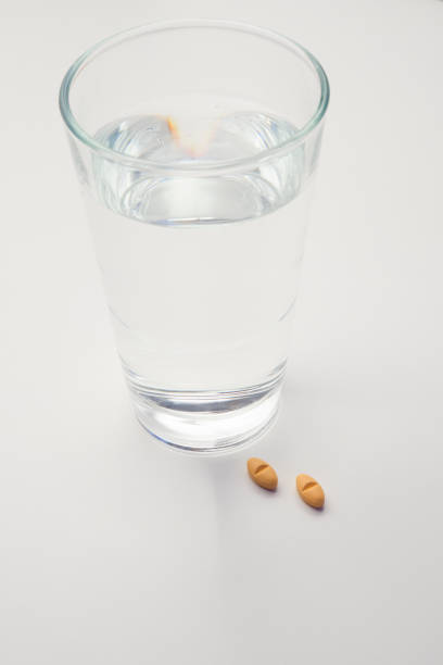 istock Pills and glass with water 641229712