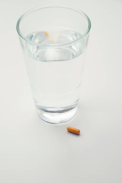 istock Pills and glass with water 641229860