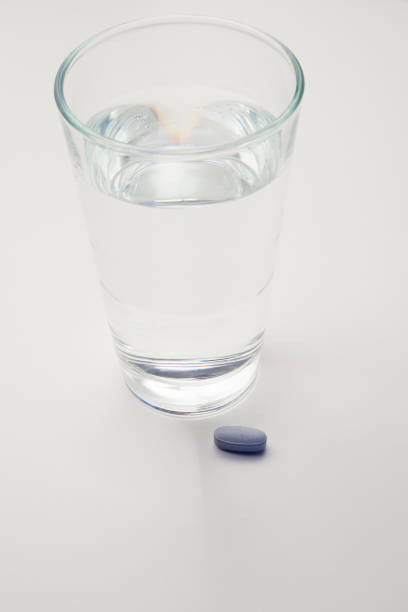 istock Pills and glass with water 641230190