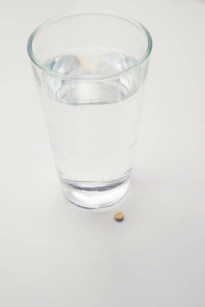 istock Pills and glass with water 641230370