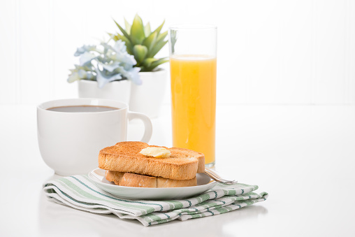 Toast and butter served with fresh coffee and orange juice.