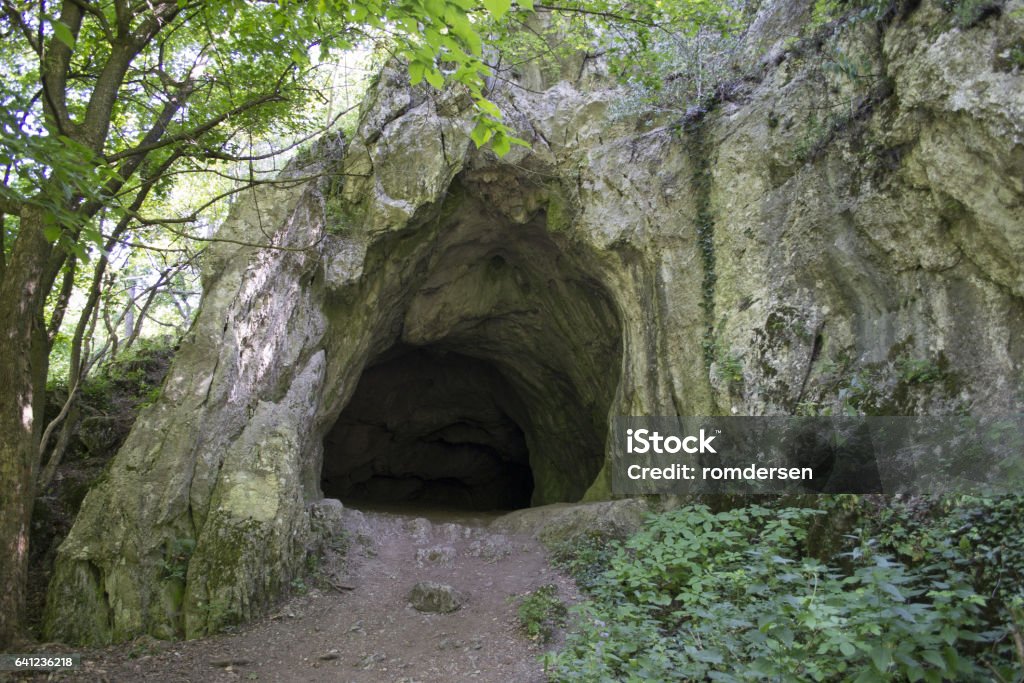 Secret cave Enter the cave in the woods Cave Stock Photo
