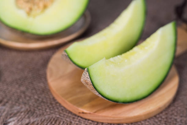 istock Green melon on wooden plate 641236614