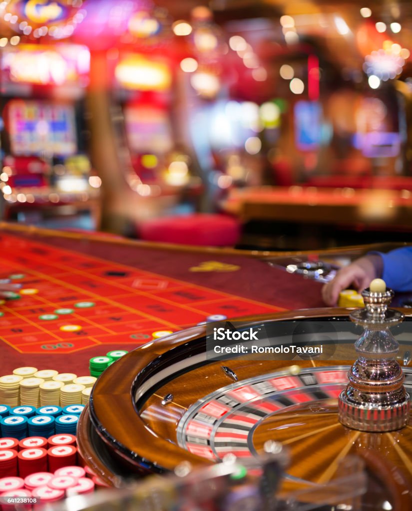 Gambling To Casino Roulette In Motion With Blurred Slot In Background Casino Stock Photo