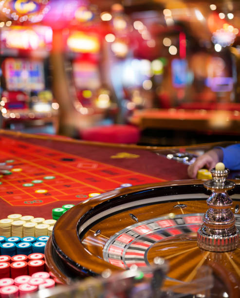 Gambling To Casino Roulette In Motion With Blurred Slot In Background roulette photos stock pictures, royalty-free photos & images