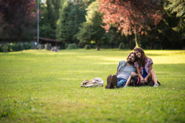 two young adult friends together talking and spending time in a public park