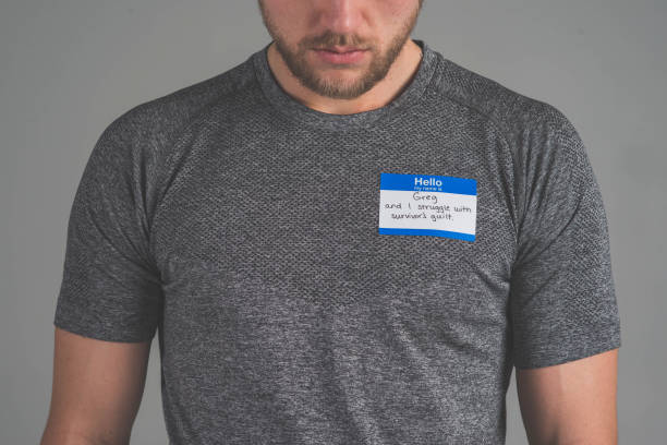 istock Man facing audience with name tag that describes struggle 