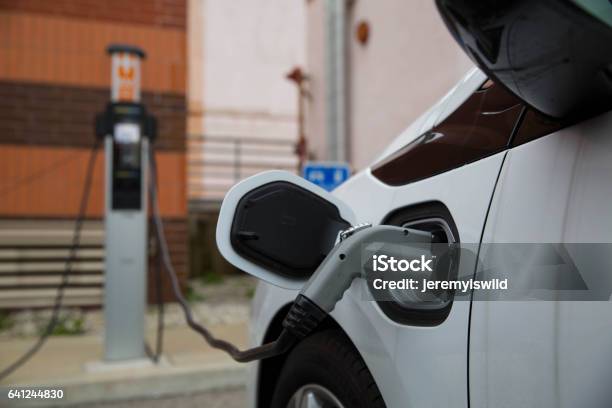 Electric Car Charging At Public Station Stock Photo - Download Image Now - Electric Car, Charging, Electric Vehicle