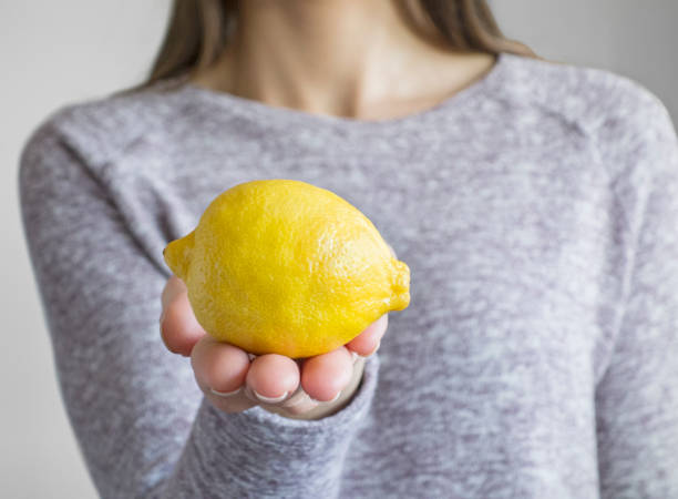 istock Woman holding lemon 641244842