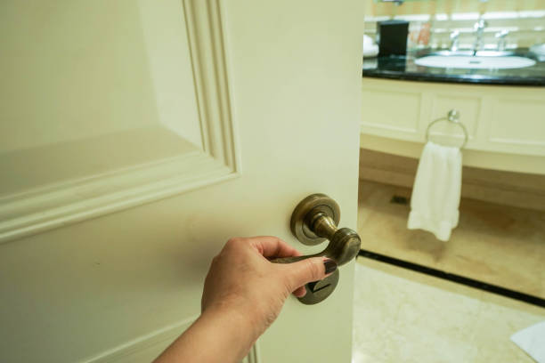 istock woman hold door handle to enter bathroom 641245736