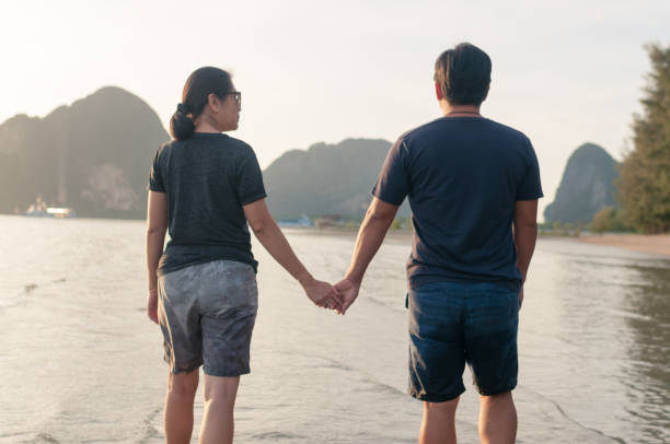 istock happy family walking on the beach 641246362
