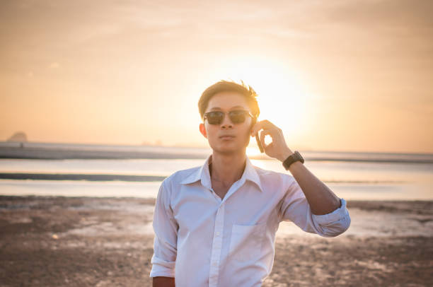 istock Business man working with laptop and smartphone beach background 641246490
