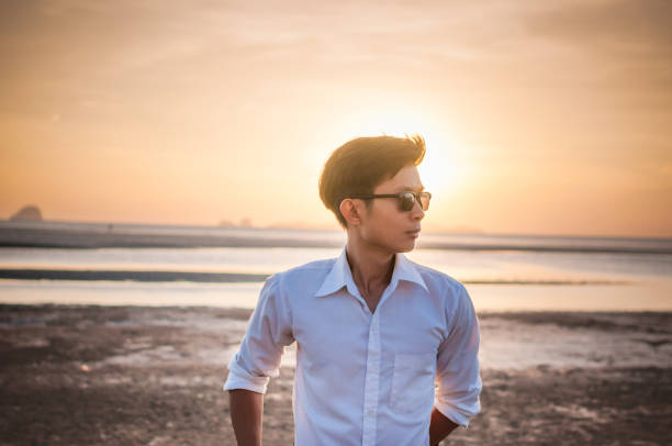 istock Young Asian Business man relaxing on the beach 641247928