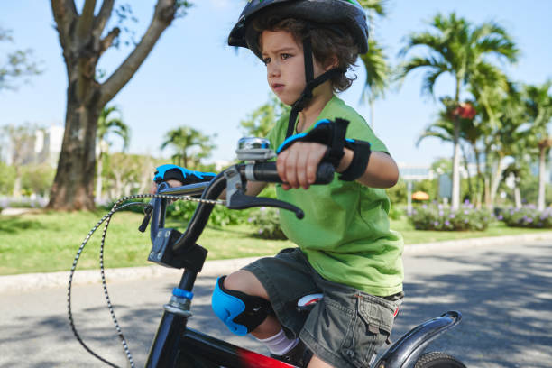 istock Worried little boy with bicycle 641249138