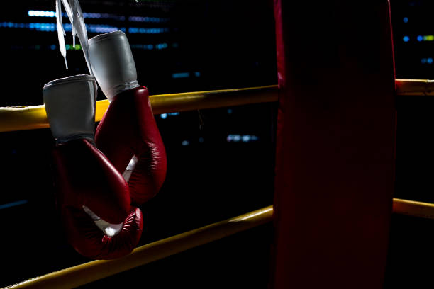 istock boxing gloves hangs off the boxing ring in a slum camp 641249330