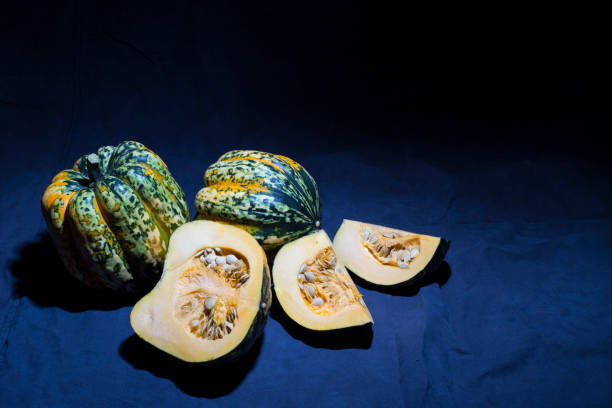 istock Speckled fresh gorgonzola pumpkins on black background 641250006