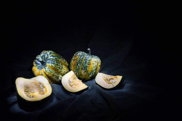 istock Speckled fresh gorgonzola pumpkins on black background 641250192