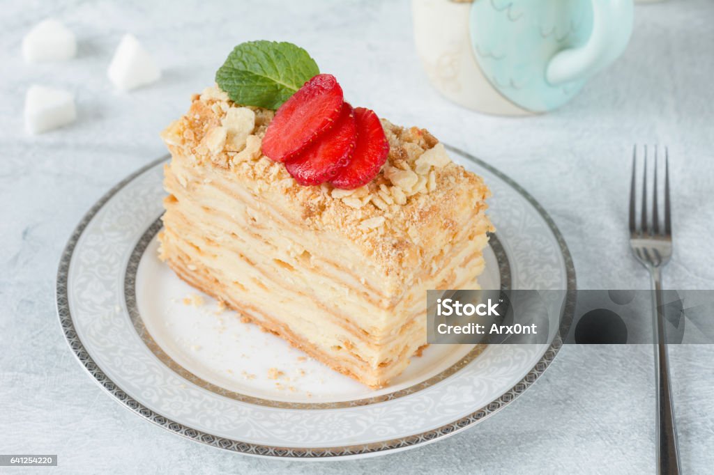 Slice of Mille Feuille cake on a plate Napoleon cake or Mille Feuille, russian cuisine layered cake with pastry cream. Close up view Backgrounds Stock Photo