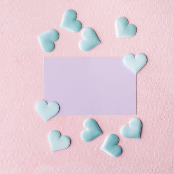 istock Purple pastel card and hearts on pink textured background 641254334