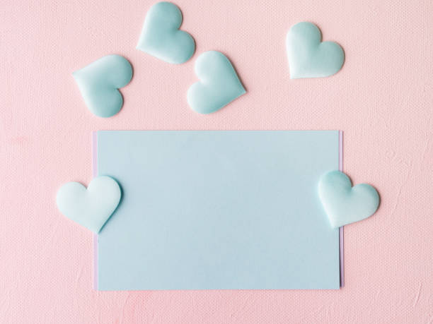 istock Green pastel card hearts on pink textured background 641254424