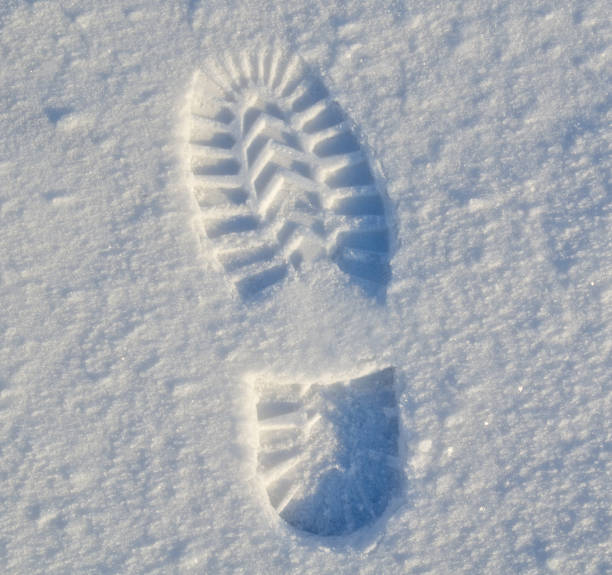 istock Winter high boot footprint on the first snow 641254432