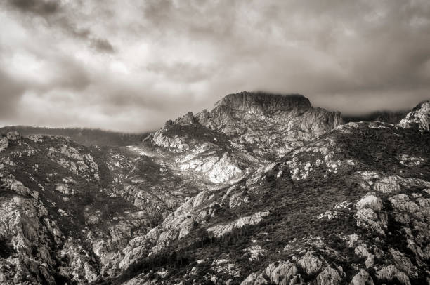 Corsican mountains in black and white a black and white view of the Corsican mountains in winter under a cloudy sky image en noir et blanc stock pictures, royalty-free photos & images