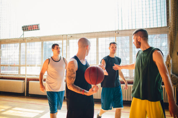 istock Group of friends playing basketball 641257342