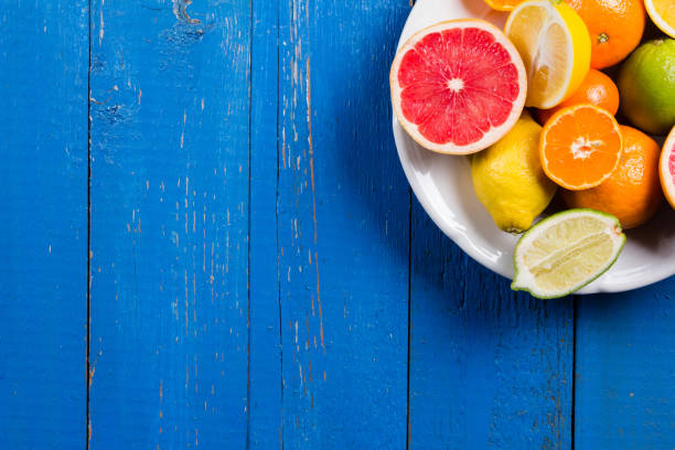 istock various types of citrus fruit on a blue painted wooden background 641257436