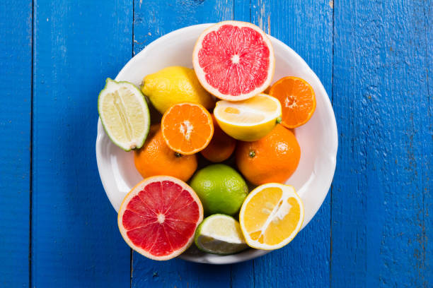 istock various types of citrus fruit on a blue painted wooden background 641260506