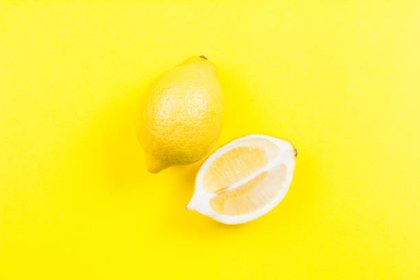 istock Whole and sliced lemon on yellow background 641260770