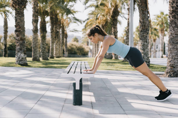 istock Woman Doing Push-ups in Park 641267666