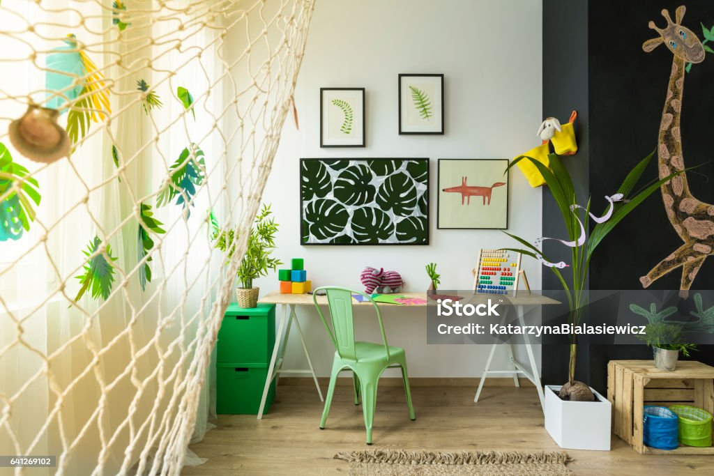 Kids study space with desk Kids study space with desk, green chair and blackboard wall Child Stock Photo