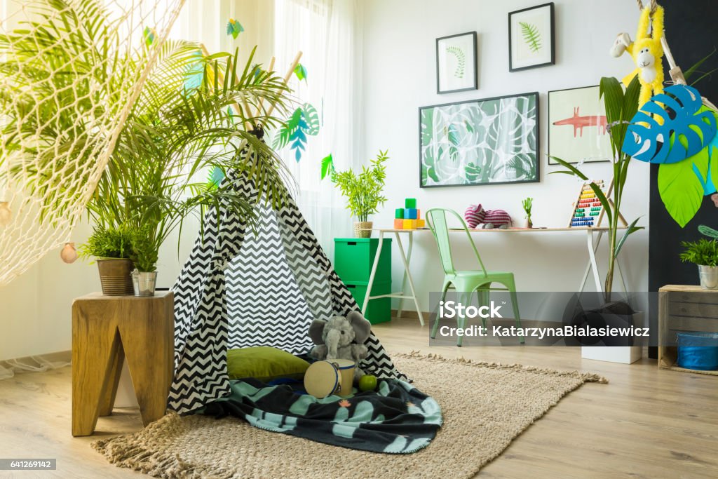 Kids room with play tent Kids room with play tent, desk and green chair Child Stock Photo