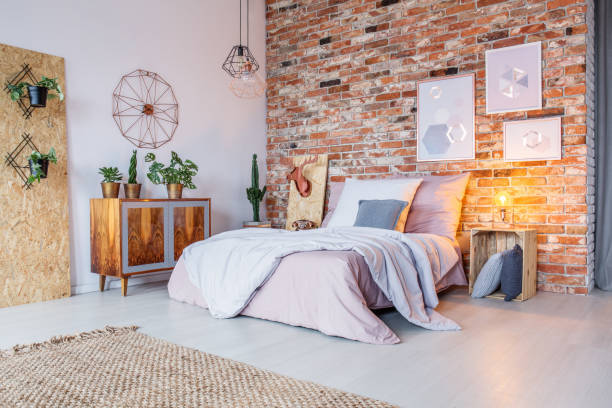 Bright bedroom with brick wall Bright bedroom with double bed, brick wall and rug double bed photos stock pictures, royalty-free photos & images