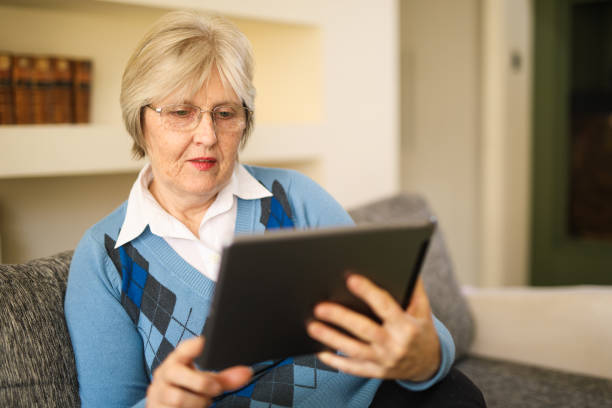 istock Senior woman using digital tablet at home 641271134