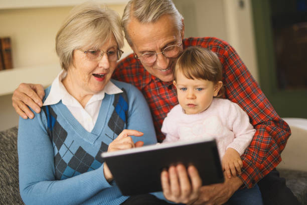 istock Grandparents and grandchild using digital tablet 641272400