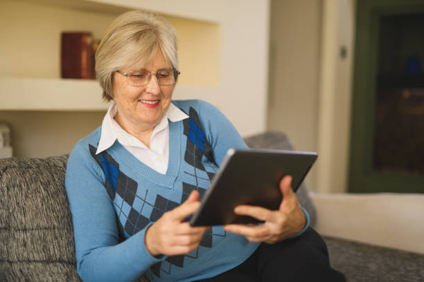 istock Senior woman using digital tablet at home 641273140