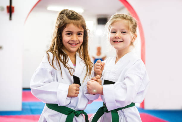 istock Two cute girls on taekwondo training, kicking and learning self-defence 641277018