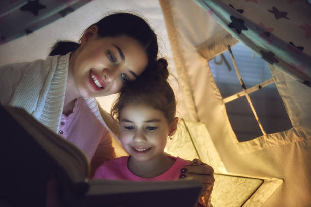 istock Mom and child reading a book 641279802