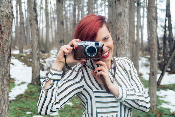 istock Young woman with camera in nature 641280114